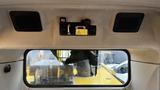 Interior view of a Caterpillar 326F L Excavator showing the roof and rear window with controls and speakers visible