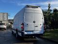 A white 2008 Dodge Sprinter Van with a high roof and rear cargo doors parked with soapy water on the body