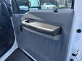 Interior view of a 2013 Ford F-250 SD driver's side door panel showcasing the door handle and armrest design