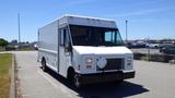 A white 2006 Ford Econoline delivery van with a boxy shape and front grille visible parked on a pavement