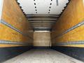 Interior view of a 2019 Hino 338 24 foot cube truck with wooden walls and a flat floor designed for cargo transport