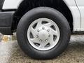 A silver wheel of a 2013 Ford E-350 with a Hankook tire showing a five-spoke design and noticeable tread pattern