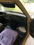 Interior of a 1978 Volvo 244 showing the dashboard with vintage controls and a purple seat cover on the driver's seat