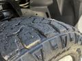 Close-up of a large, rugged off-road tire tread designed for a 2022 RAM 3500 showcasing deep grooves and a robust pattern for traction