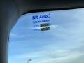 A 2011 Chevrolet Avalanche with a service reminder sticker on the windshield displaying service details and next service date