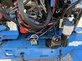 Close-up view of the engine components and hydraulic system of a 2012 Genie Z 45/25 including wires hoses and small mechanical parts