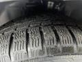 A close-up view of a tire on a 2014 Ford Transit Connect showing tread patterns and texture