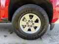 Close-up view of a 2018 GMC Canyon wheel with a Goodyear Wrangler tire featuring a beige and silver rim design