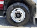 A close-up view of a 1994 Volvo FE 42 tire featuring a shiny chrome wheel rim with bolts and the Michelin logo on the sidewall