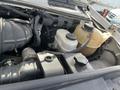 Engine compartment of a 2009 Ford Econoline showing various components including coolant reservoir and hoses
