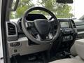 Interior view of a 2020 Ford F-350 SD showing the steering wheel dashboard and center console with various controls and a touchscreen display