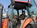 2014 Kubota M7060 tractor cabin with a steering wheel and control panel visible seating area and large glass windows