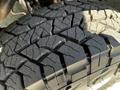 Close-up of a rugged tire tread from a 2017 Mercedes-Benz Sprinter showcasing deep grooves and patterns designed for traction and stability on various surfaces