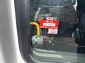 A 2018 Chevrolet Express with a sticker displaying a certificate of approval attached to a window