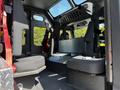 Interior view of a 2006 Emergency One Fire Truck featuring seating for firefighters and equipped with safety harnesses and compartments for gear