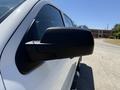A close-up of the side mirror of a 2016 GMC Sierra 1500 in white with a black mirror casing