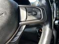 Close-up of the steering wheel control buttons of a 2019 RAM 1500 featuring buttons for set cancel and resume functions along with a gear limit button