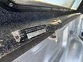 A 2014 Ford F-150 with a visible manufacturer label attached to the interior of the truck bed