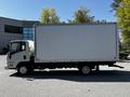 A 2007 GMC W3500 box truck with a white cargo area and a cab in the front, parked on a paved surface