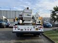 A 2013 International Durastar 4300 bucket truck with an Altec aerial lift attached at the rear