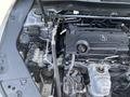 Engine compartment of a 2017 Acura TLX featuring the engine, various components, and hoses arranged around the engine block