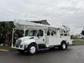 A white 2007 International 4200 truck with an extended boom arm and an aerial lift bucket mounted on top of a raised platform