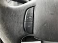 Close-up of a 2009 Ford Econoline steering wheel with buttons labeled ON and OFF