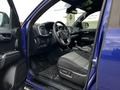 Interior of a 2022 Toyota Tacoma showing the driver's seat dashboard and controls with cloth seating and a manual transmission gearbox