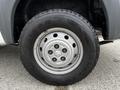 Close-up of a silver wheel from a 2018 RAM Promaster featuring a Goodyear Wrangler tire with prominent tread patterns and a sturdy rim design