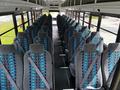 Interior of a 2022 Blue Bird BB Conventional school bus featuring rows of gray seats with blue and green striped patterns
