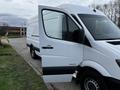 A 2016 Mercedes-Benz Sprinter van with an open side door showcasing a spacious cargo area and sleek white exterior