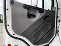 The image shows the interior door panel of a 2006 Freightliner M2 112 featuring a gray finish and controls for the window and door handle