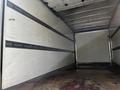 Interior of a 2019 Hino 195 truck showing an empty cargo space with metal tracks along the walls for securing loads