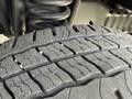 Close-up of a tire from a 2010 Ford Econoline showing detailed tread patterns and wear on the rubber surface