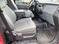 Interior of a 2011 Ford F-250 SD featuring gray leather seats and a center console in a pickup truck configuration