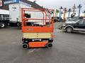 A 2024 JLG R1932 scissor lift with an orange frame and beige platform raised partially in the foreground