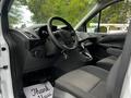 Interior of a 2016 Ford Transit Connect showing the driver's seat steering wheel and dashboard with a key in the ignition
