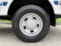 A close-up view of a white wheel and tire of a 2015 Ford F-350 SD showing the tire tread and the rim design