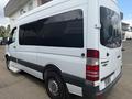 2009 Dodge Sprinter Van with a white exterior and dark tinted windows viewed from the rear side showing the rear lights and sliding side door