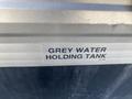 Label on a grey water holding tank of a 2016 Jayco 265RLSW trailer