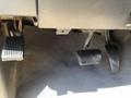 A close-up view of the foot pedals in a 2011 RAM 1500 including the accelerator pedal and brake pedal both featuring rubber grips