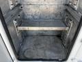 Interior view of a 2004 Freightliner M2 truck showing an empty metal cargo area with a removable shelf