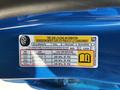 A blue 2021 Chevrolet Colorado with a tire and loading information sticker, detailing occupants, tire specifications, and pressure requirements