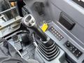 The image shows the control panel and joystick of a 2022 Hyundai R55-9A excavator with various buttons and switches visible