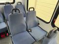 Interior seating area of a 2017 Chevrolet Express with blue upholstered seats featuring safety belts and black armrests