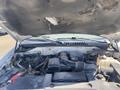 A 2013 Ford Expedition with its hood raised showing the engine compartment and various engine components