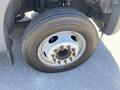 The image shows a close-up of a tire mounted on a 2015 Ford F-450 SD with visible lug nuts and a treaded surface