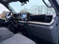 Interior view of a 2023 Ford F-250 with a modern dashboard featuring a large touchscreen display and plush seating
