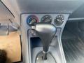 The console of a 2013 Ford Transit Connect with a gear shift lever and control knobs for temperature and fan speed