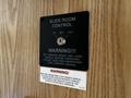 Control panel for slide room operation in a 2000 Ford Motorhome featuring warning labels and a key slot for activation